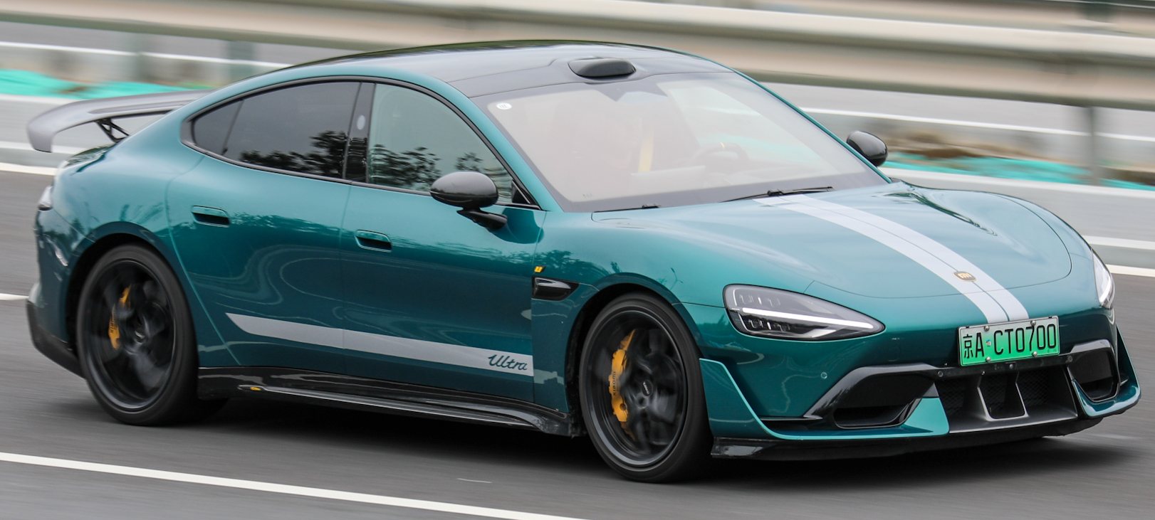 Aqua Green Xiaomi SU7 Ultra production saloon photographed in motion